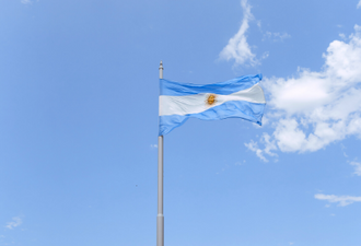 Picture of a blue sky with and Argentinian flag