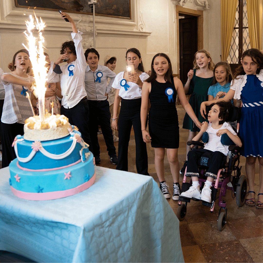 Sofia and friends watch a sparkling candle on her cake