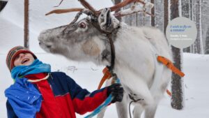 Boy in snow gear with reindeer