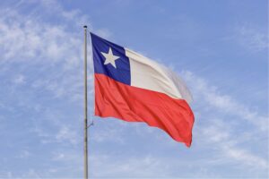 A Chilean flag in front of a cloudy blue sky