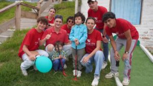 Volunteers from Fundacion Thomas Viteri Schonberger with a child