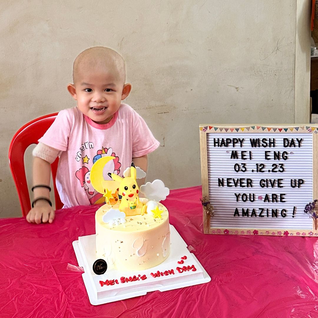 Mei Eng celebrates her wish day with a yellow cake