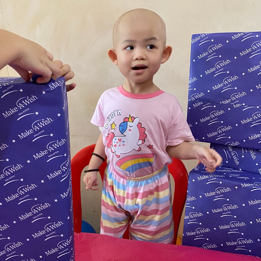 Mei Eng looks delighted to be surrounded by wrapped gifts