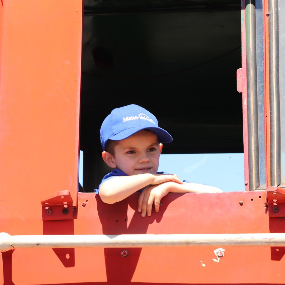 Wish Child Jasper looks out the window of a steam train