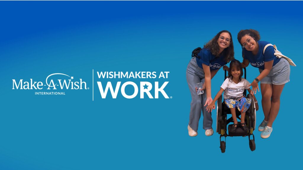 Two smiling women in blue Make-A-Wish shirts stand behind a young girl in a wheelchair, all posing happily. The text reads Make-A-Wish International Wishmakers at Work on a blue background.