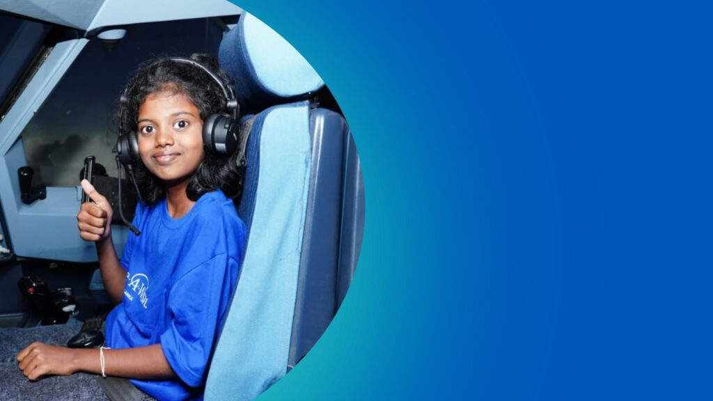 A smiling child wearing a blue Make-A-Wish t-shirt and pilot headphones sits in an aeroplane cockpit, giving a thumbs up. A large portion of the image is cropped by a circular frame against a solid blue background.