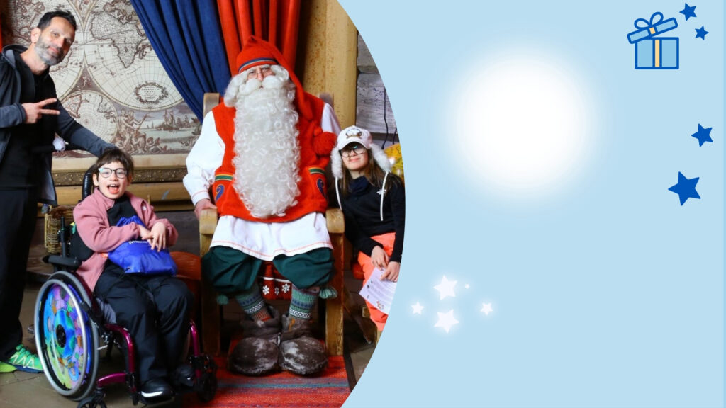 A photo of a father, a girl in a wheelchair, and a second girl with Father Christmas in a rustic, festive room. The right side features Unwrap the Power of a Wish on a blue overlay with a gift icon and stars.